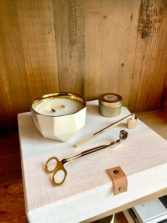 High Maintenance Gift Set  featuring our full sized candle in a white asymmetric vessel. It also has our mini travel sized candle. Along with our candle accessories which includes a set of the candle wick snuffer in either  black, gold, or silver